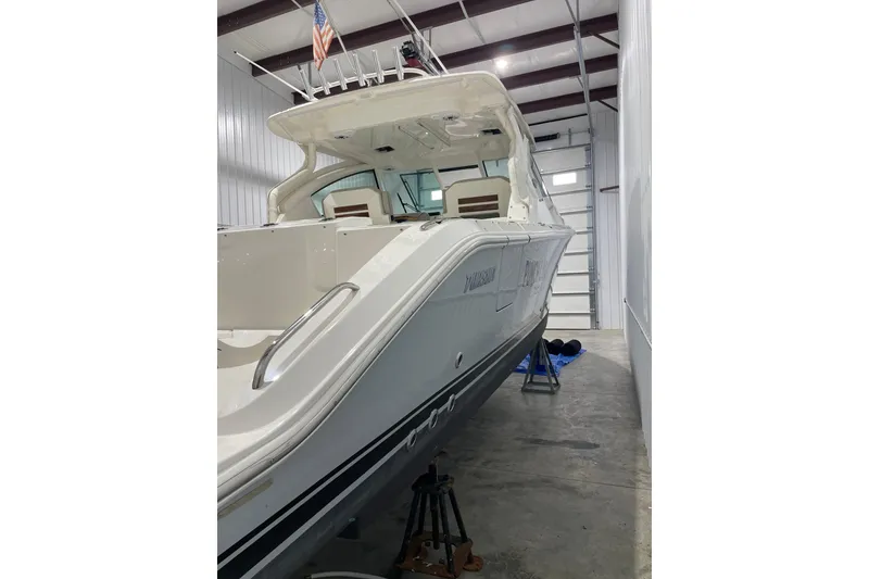 Slide: The Image of 2024 Pursuit DC 326 Dual Console helm with steering wheel and control panel. - 5