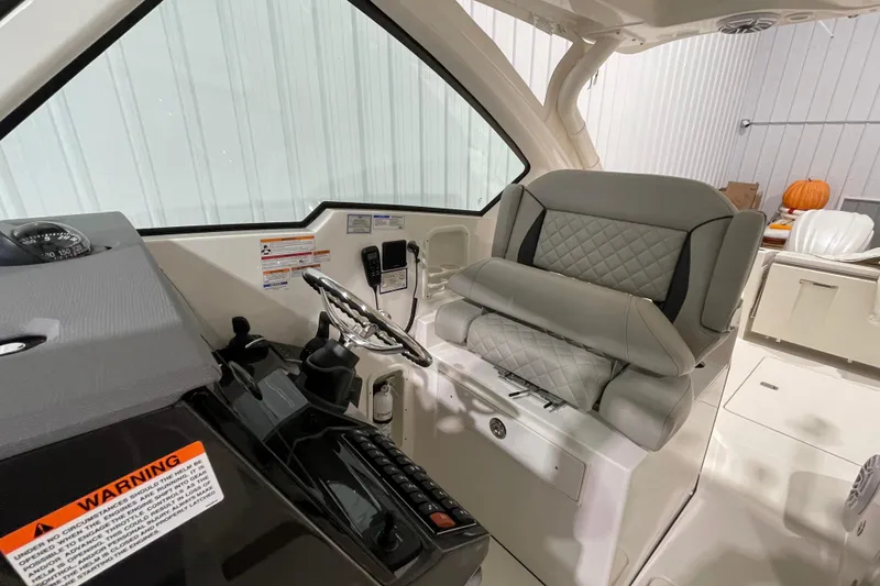 Slide: The Image of 2024 Pursuit DC 326 Dual Console boat in storage, side view. - 8