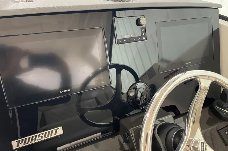 Slide: The Image of 2024 Pursuit DC 326 Dual Console boat with Yamaha engine in a garage setting. - 9