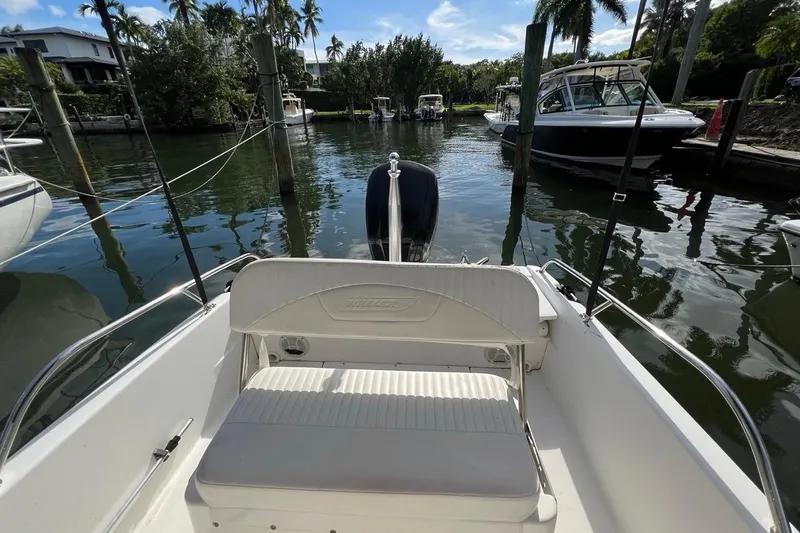 Slide: The Image of 2016 Boston Whaler 170 Dauntless boat docked in a scenic marina setting. - 14