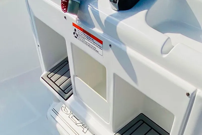 Slide: The Image of 2021 Sea Hunt Ultra 265 SE boat interior with storage compartments and safety label. - 15