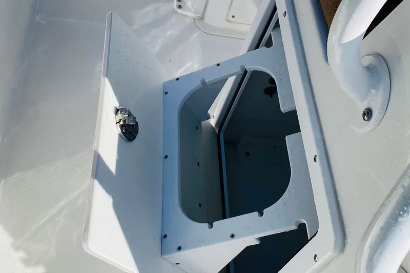 Slide: The Image of Open storage compartment on 2021 Sea Hunt Ultra 265 SE boat. - 16