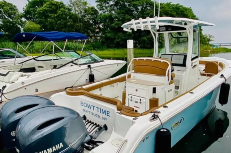 Slide: The Image of 2021 Sea Hunt Ultra 265 SE boat docked with twin Yamaha engines. - 2