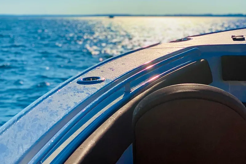 Slide: The Image of 2021 Sea Hunt Ultra 265 SE boat on sparkling blue water. - 20