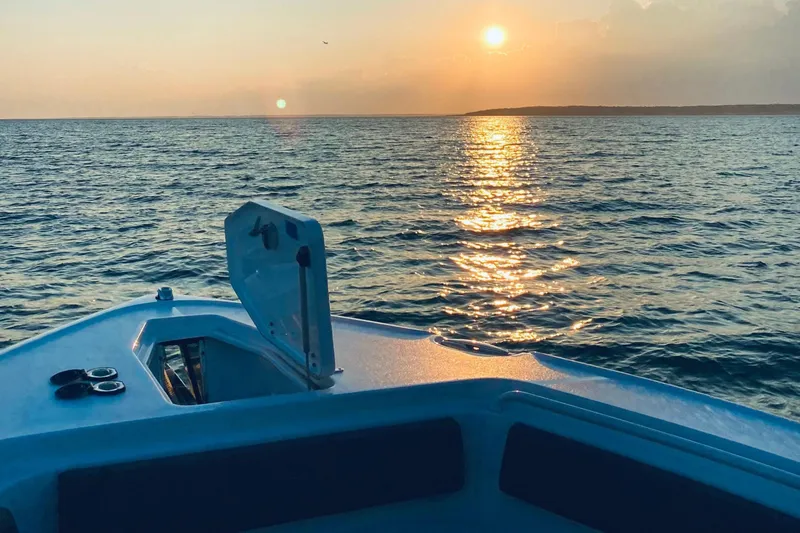 Slide: The Image of Sunset view from a 2021 Sea Hunt Ultra 265 SE boat on the ocean. - 24