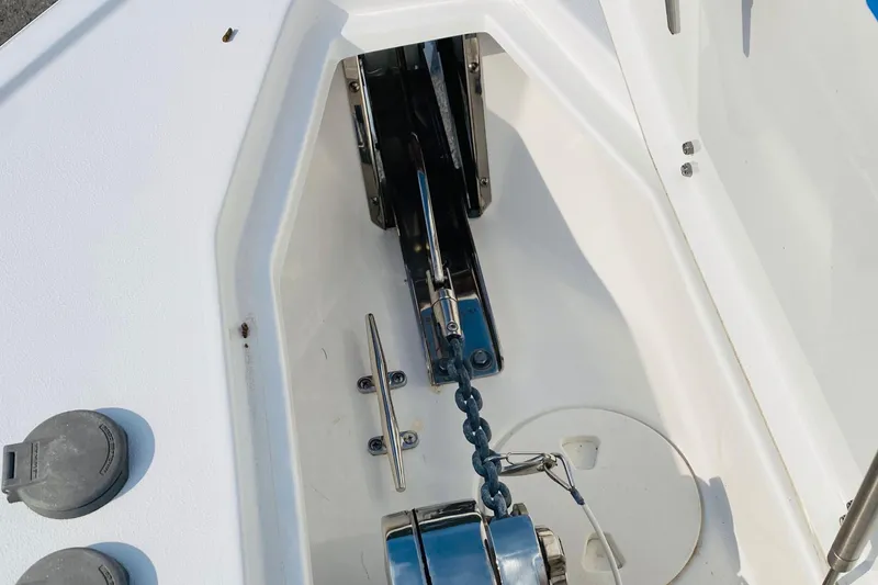 Slide: The Image of Anchor compartment of 2021 Sea Hunt Ultra 265 SE boat with chain and cleat. - 25