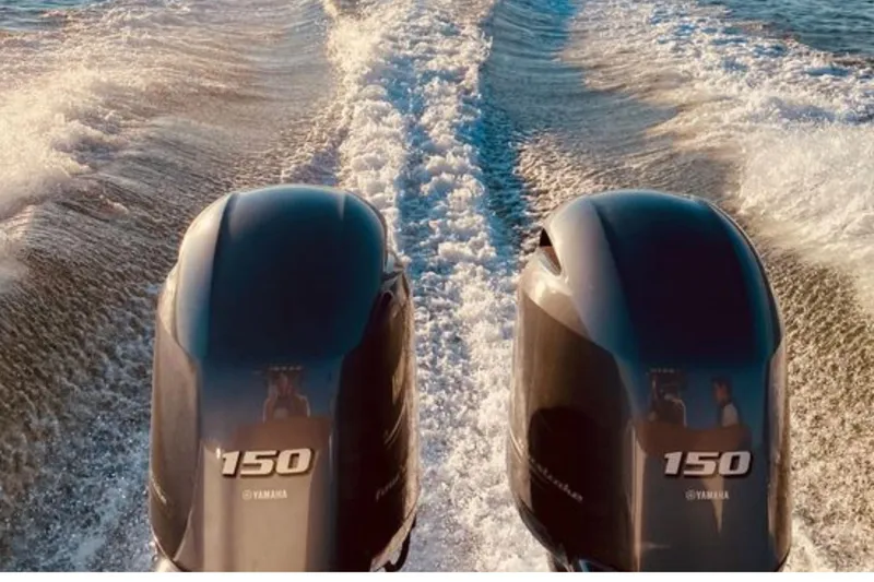 Slide: The Image of Twin Yamaha 150 engines powering a 2021 Sea Hunt Ultra 265 SE boat. - 26