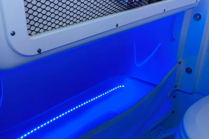 Slide: The Image of Interior of 2021 Sea Hunt Ultra 265 SE boat with blue LED lighting. - 32