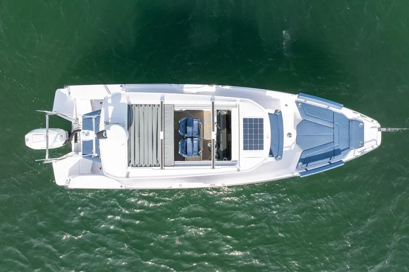 Slide: The Image of Overhead view of 2026 Axopar 29 XC Cross Cabin boat on water. - 11