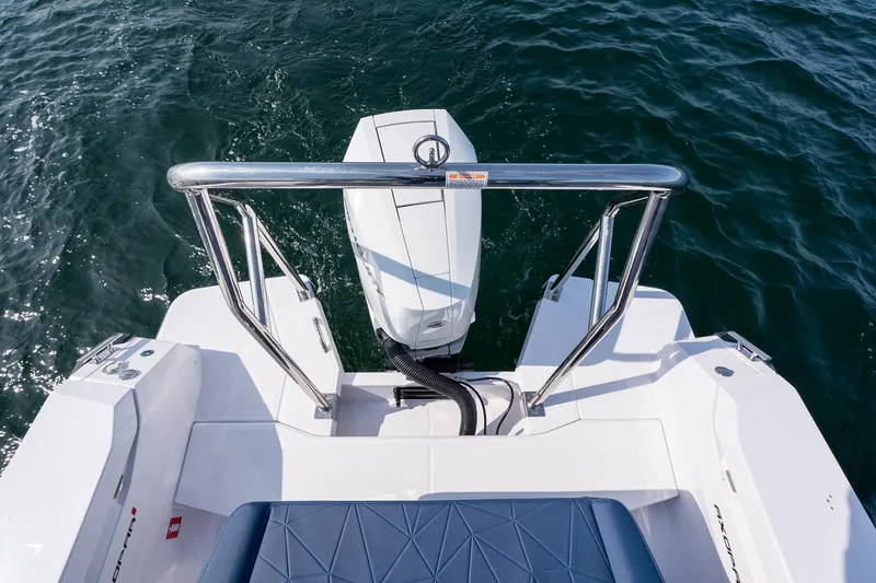 Slide: The Image of 2026 Axopar 29 XC Cross Cabin boat with outboard motor on water. - 16