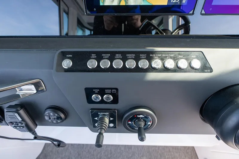 Slide: The Image of Control panel of 2026 Axopar 29 XC Cross Cabin with various switches and controls. - 32