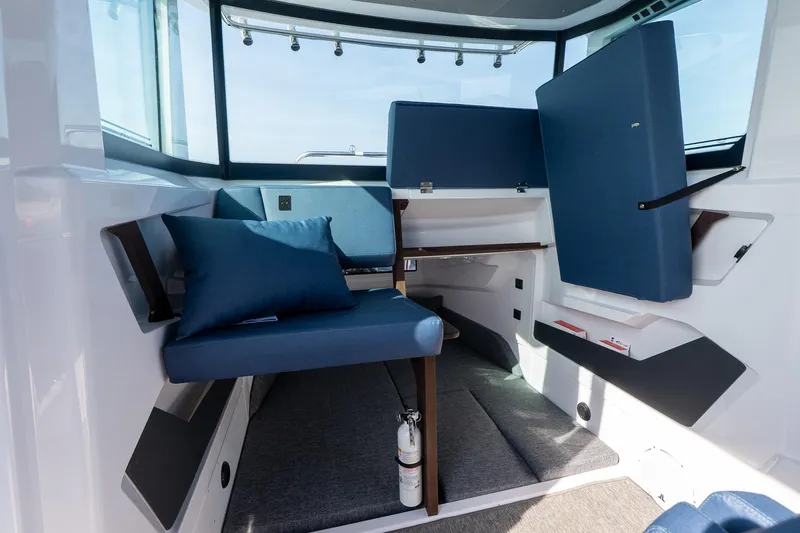 Slide: The Image of Interior of 2026 Axopar 29 XC Cross Cabin with blue seating and modern design. - 35