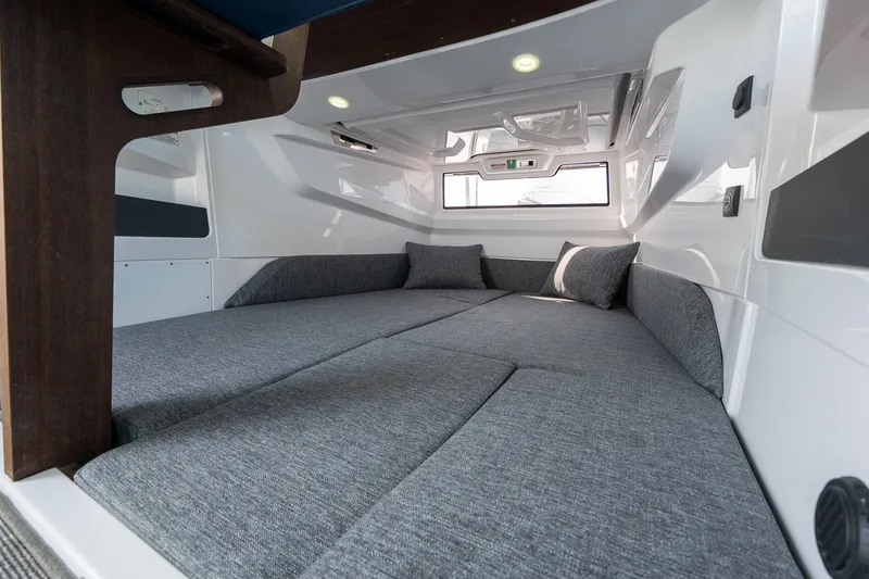 Slide: The Image of Interior cabin of 2026 Axopar 29 XC Cross Cabin with modern gray bedding. - 37