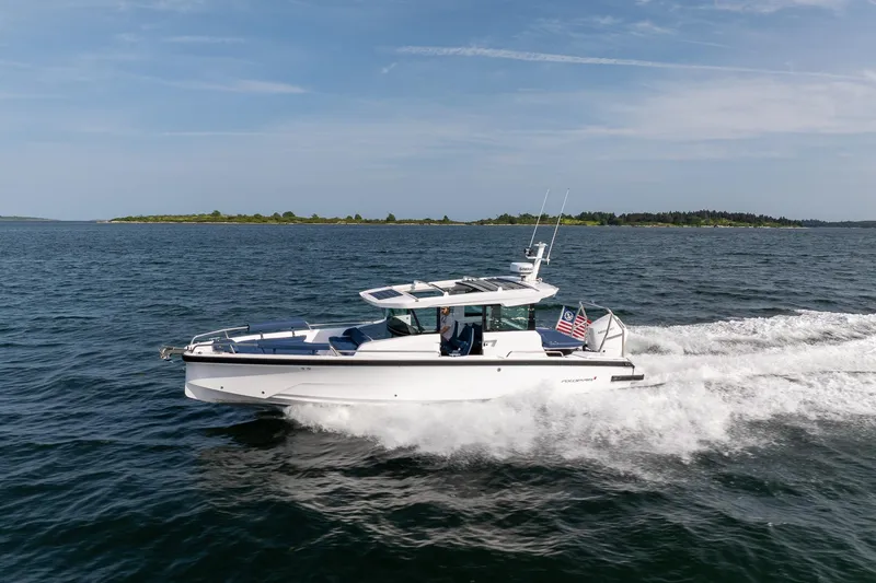 Slide: The Image of 2026 Axopar 29 XC Cross Cabin cruising on open water, showcasing sleek design and performance. - 4