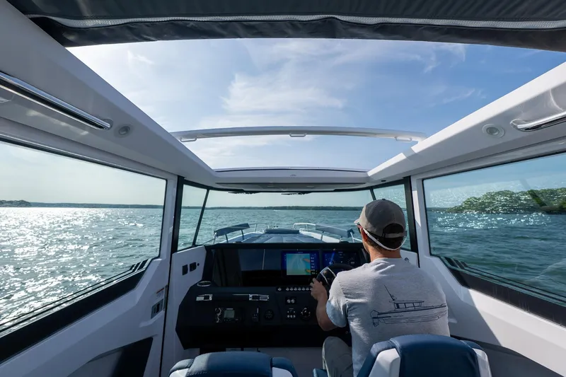 Slide: The Image of Interior view of 2026 Axopar 29 XC Cross Cabin on open water, sunny day. - 7