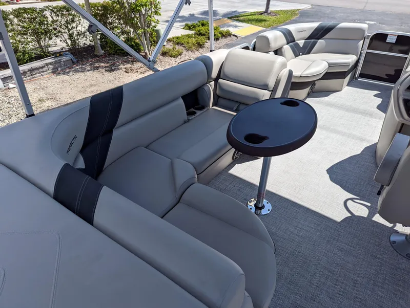 Slide: The Image of 2022 Trifecta 20C LE pontoon boat interior with seating and table. - 11