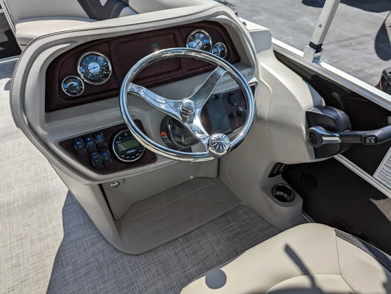 Slide: The Image of 2022 Trifecta 20C LE boat dashboard with steering wheel and control panel. - 7
