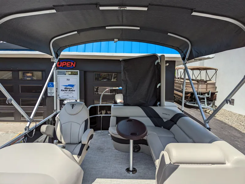 Slide: The Image of 2022 Trifecta 20C LE pontoon boat interior with spacious seating and cup holders. - 9