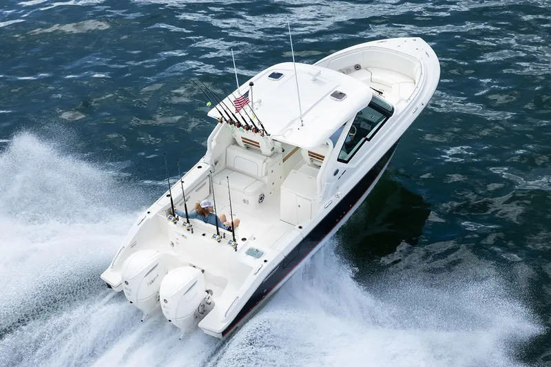 Slide: The Image of Manufacturer Provided Image: 2025 Pursuit DC 326 Dual Console boat cruising on open water. - 3