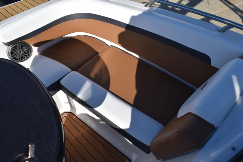 Slide: The Image of 2023 Starcraft SVX 210 IO boat interior with brown and white seating. - 10