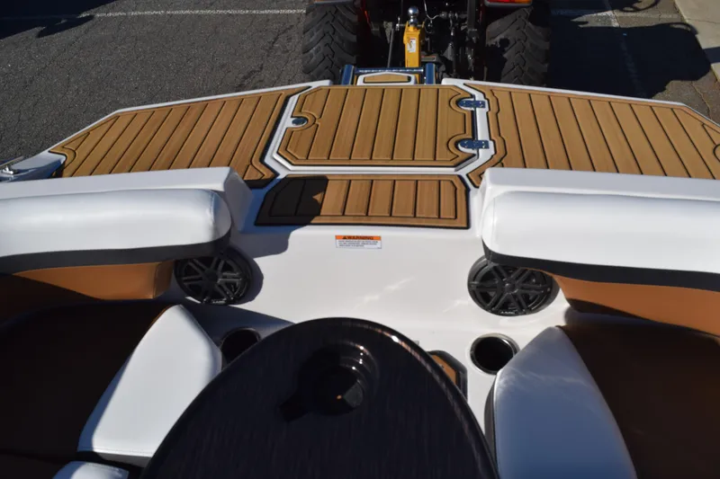 Slide: The Image of 2023 Starcraft SVX 210 IO boat interior with wood accents and seating. - 12