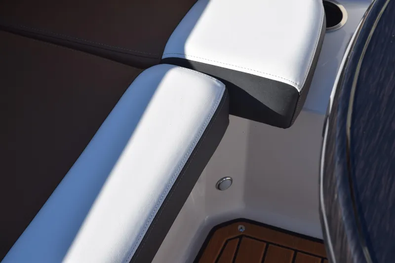 Slide: The Image of 2023 Starcraft SVX 210 IO boat interior with white and black seating detail. - 13