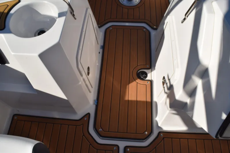 Slide: The Image of 2023 Starcraft SVX 210 IO boat interior with teak flooring and white fixtures. - 21