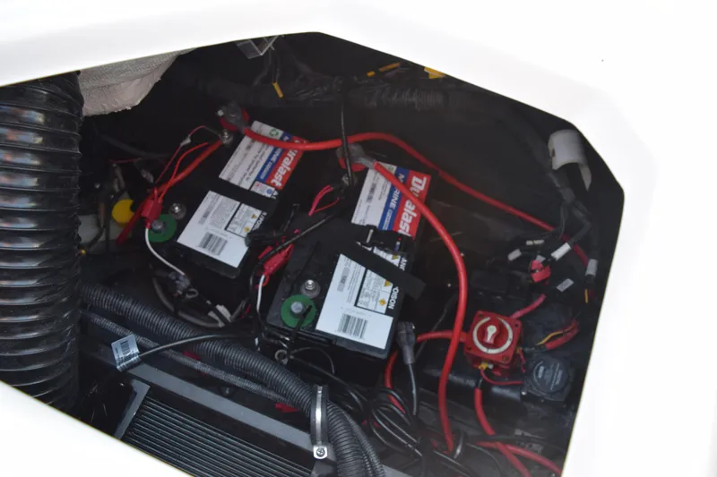 Slide: The Image of 2023 Starcraft SVX 210 IO boat battery compartment with wiring and components. - 25