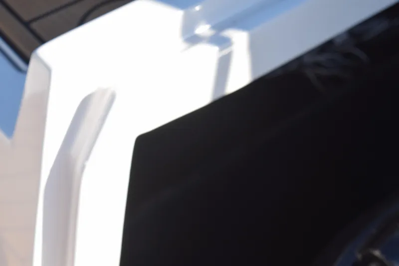 Slide: The Image of Close-up of 2023 Starcraft SVX 210 IO boat detail, featuring sleek white and black design. - 27