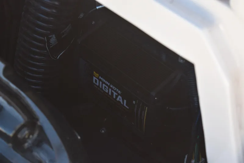 Slide: The Image of 2023 Starcraft SVX 210 IO boat engine compartment with Minn Kota digital component. - 28