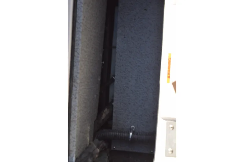 Slide: The Image of Interior compartment of 2023 Starcraft SVX 210 IO boat, showing storage space. - 29