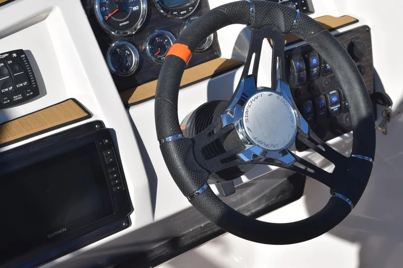 Slide: The Image of 2023 Starcraft SVX 210 IO boat dashboard with steering wheel and gauges. - 30