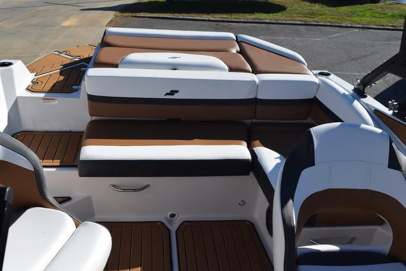 Slide: The Image of 2023 Starcraft SVX 210 IO boat interior with brown and white seating. - 33