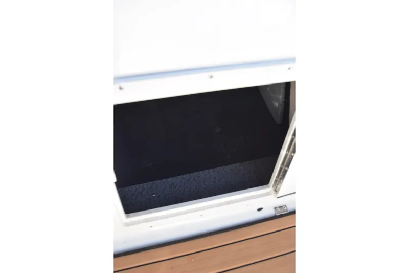 Slide: The Image of 2023 Starcraft SVX 210 IO boat storage compartment with open hatch. - 34