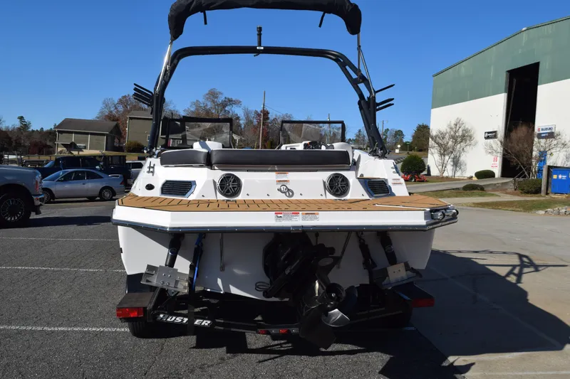 Slide: The Image of 2023 Starcraft SVX 210 IO boat, rear view, parked outdoors on a sunny day. - 4