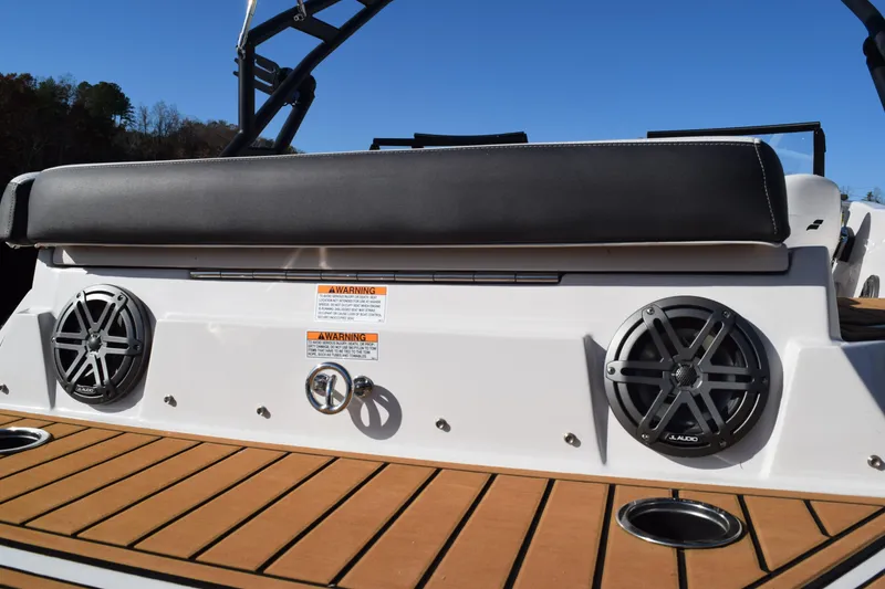 Slide: The Image of 2023 Starcraft SVX 210 IO boat with speakers and cushioned seating on deck. - 6
