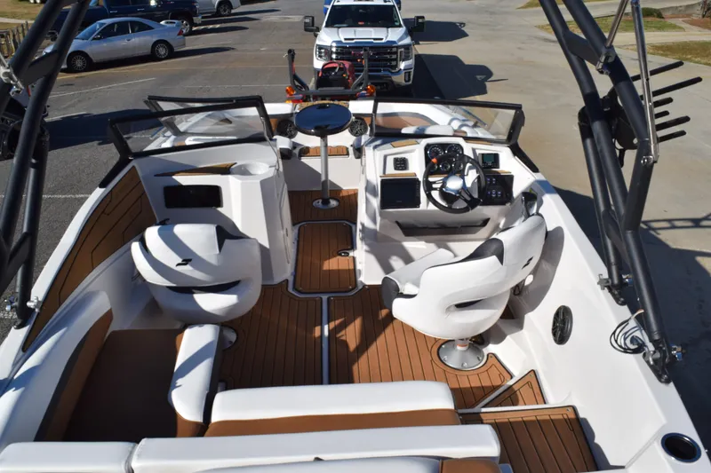 Slide: The Image of 2023 Starcraft SVX 210 IO boat interior with modern seating and dashboard. - 8