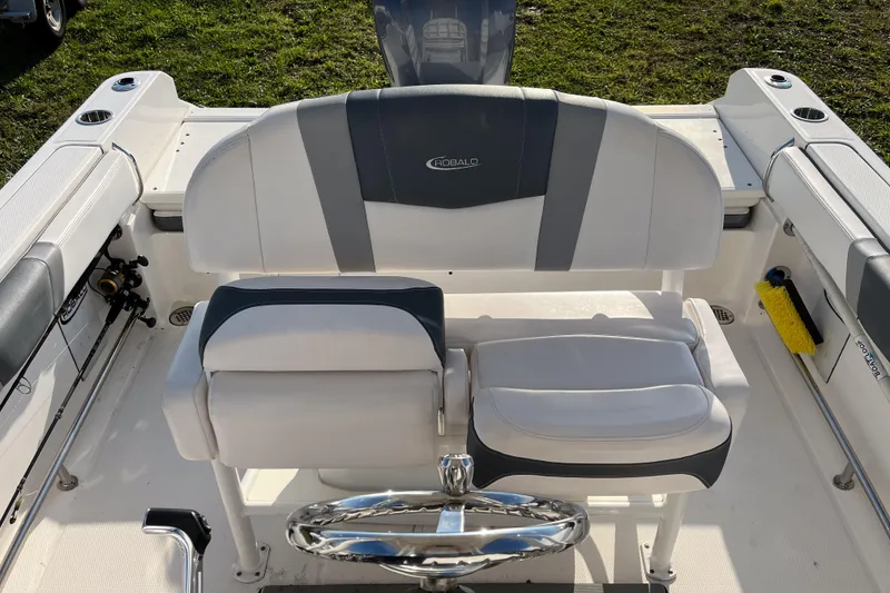 Slide: The Image of 2021 Robalo R230 Center Console boat interior with steering wheel and seating. - 10
