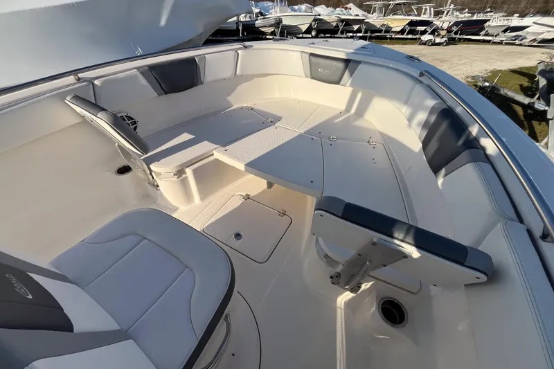 Slide: The Image of 2021 Robalo R230 Center Console boat interior with seating and table. - 11