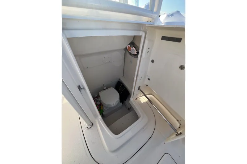 Slide: The Image of 2021 Robalo R230 Center Console boat interior with compact marine toilet. - 15