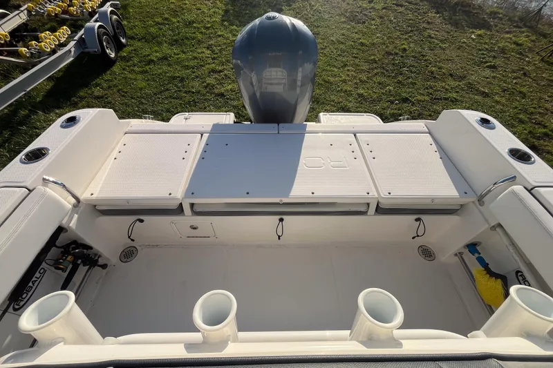 Slide: The Image of 2021 Robalo R230 Center Console boat interior with engine and storage compartments. - 2