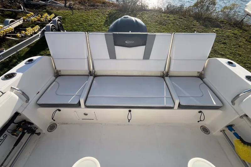 Slide: The Image of 2021 Robalo R230 Center Console boat interior with cushioned seating and storage compartments. - 3