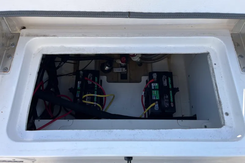 Slide: The Image of 2021 Robalo R230 Center Console battery compartment with dual marine batteries. - 5