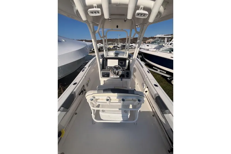Slide: The Image of 2021 Robalo R230 Center Console boat interior with steering wheel and navigation equipment. - 7