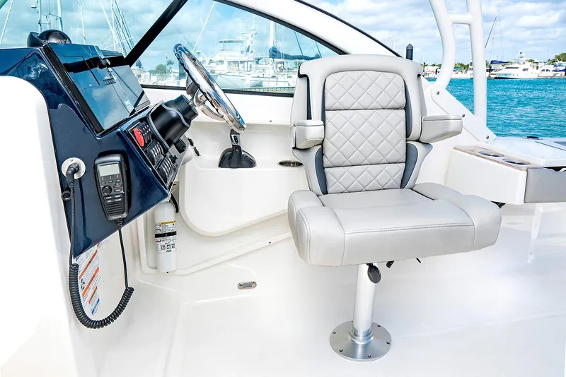 Slide: The Image of Manufacturer Provided Image: 2025 Pursuit DC 246 Dual Console boat interior with captain's chair and control panel. - 7