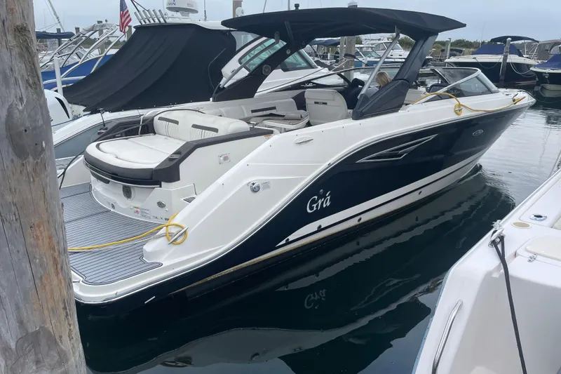 The Image of 2018 Sea Ray SLX 310 boat docked, featuring sleek design and spacious seating. - 0