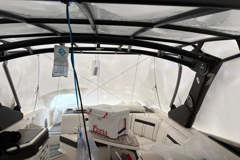Slide: The Image of 2018 Sea Ray SLX 310 boat interior with cooler and protective cover. - 4