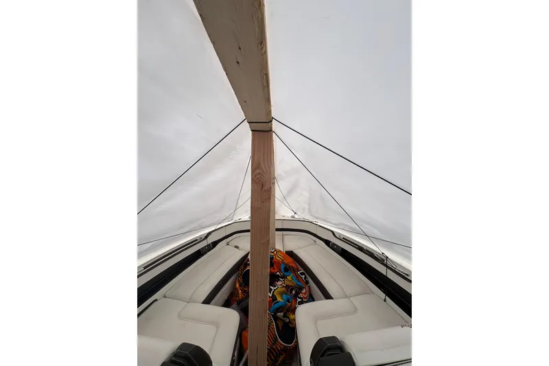 Slide: The Image of 2018 Sea Ray SLX 310 boat interior under protective cover. - 6