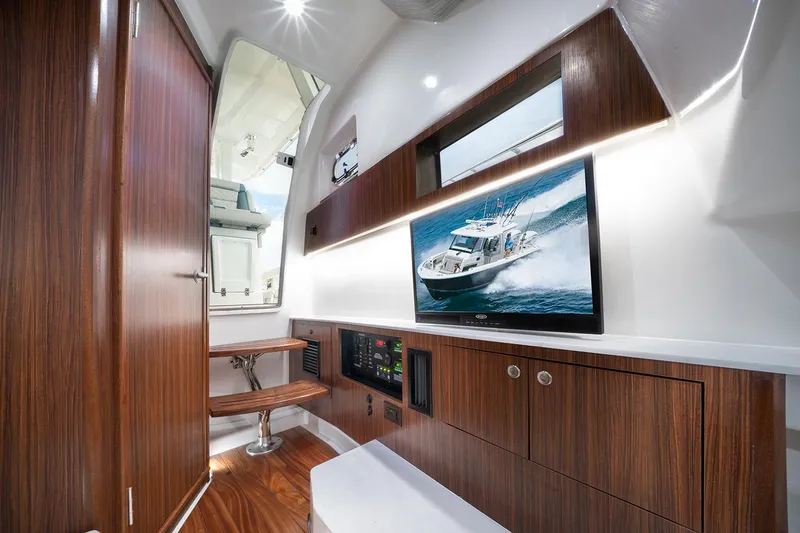 Slide: The Image of Manufacturer Provided Image: Luxurious interior of 2025 Pursuit S 358 Sport boat with wood finishes and modern amenities. - 12