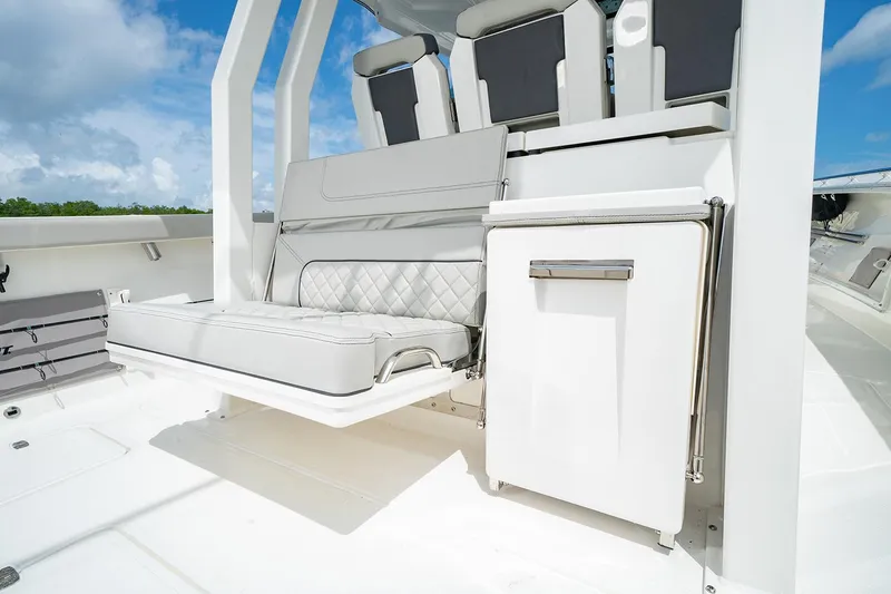 Slide: The Image of Manufacturer Provided Image: 2025 Pursuit S 358 Sport boat interior with cushioned seating and storage. - 9